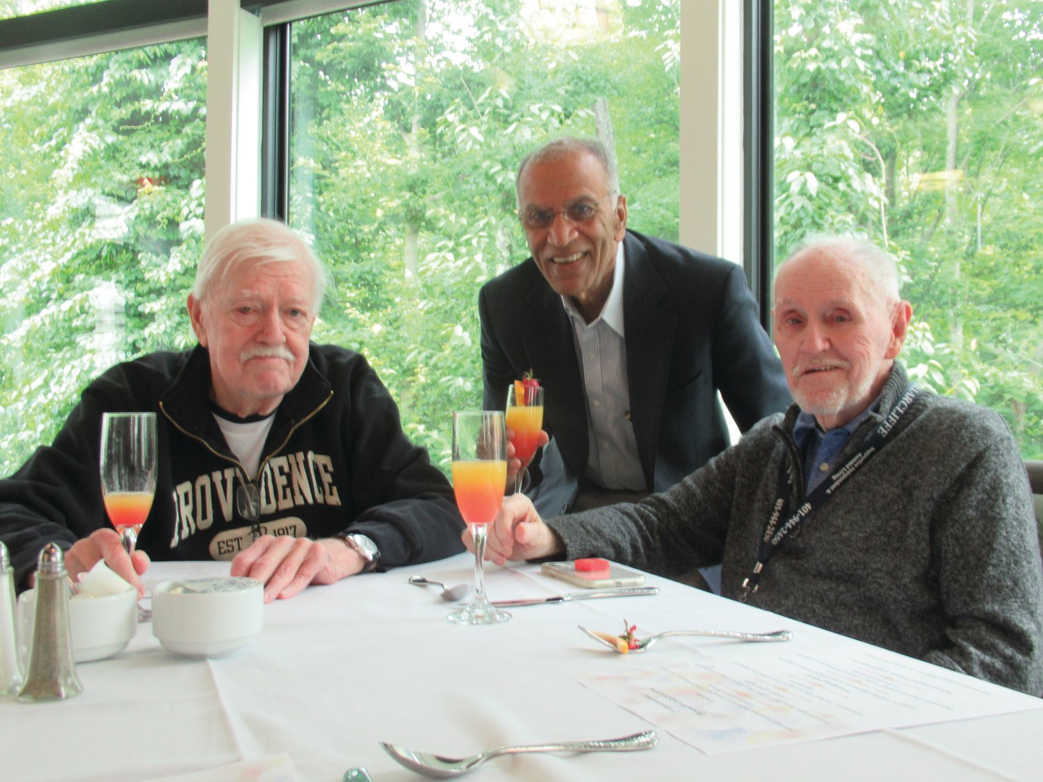 TALWAR’S TOAST: Akshay Talwar, who owns the ever-expanding Briarcliffe Campus in Johnson, offers a toast to Kerry O’Neil (left) and Jim Smith during last week’s First Anniversary Brunch at The Preserve.
